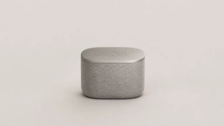 A single photoreal render of a portable bluetooth speaker presented alone on a clean pale board