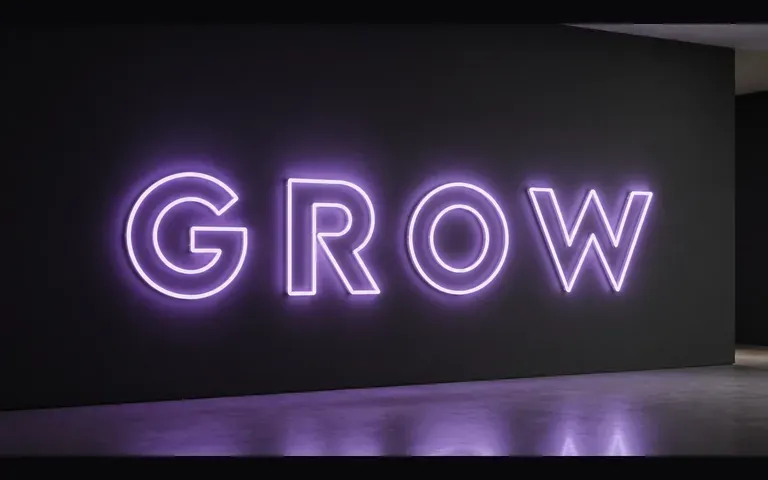 The word GROW in glowing neon lettering