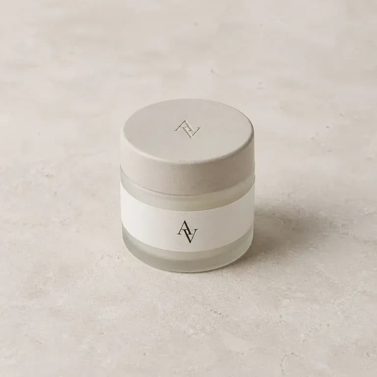 A monogram printed small on an unbranded jar label and debossed on its lid