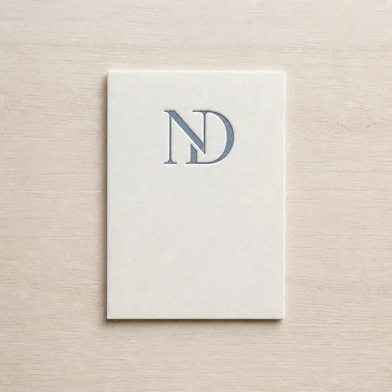 A personal monogram letterpressed alone on a heavy uncoated card