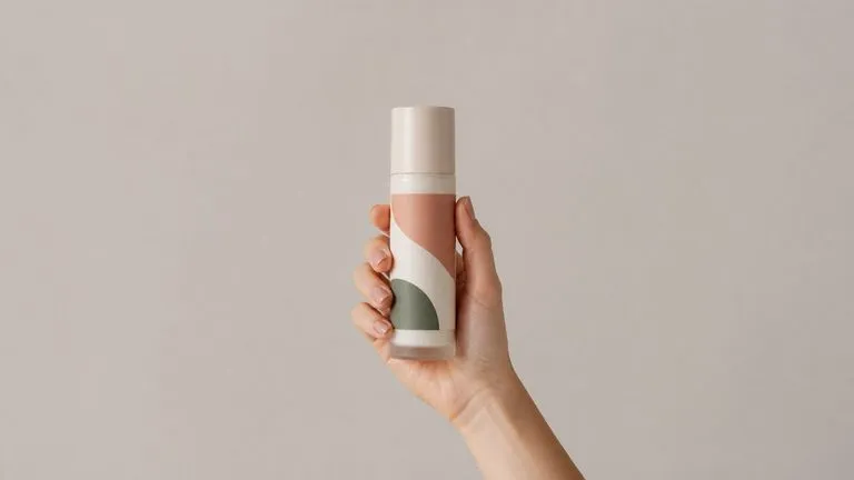 A close-up of a hand holding a bottle with the label graphic staying crisp and undistorted
